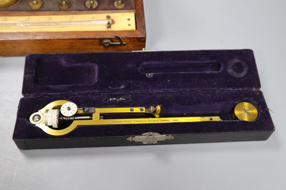 A 19th century brass Polar Planimeter (Amsler short-arm type) by Stanley, with weight and two other items,